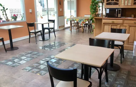 Comedor compartido de la residencia, con mesas y cocina